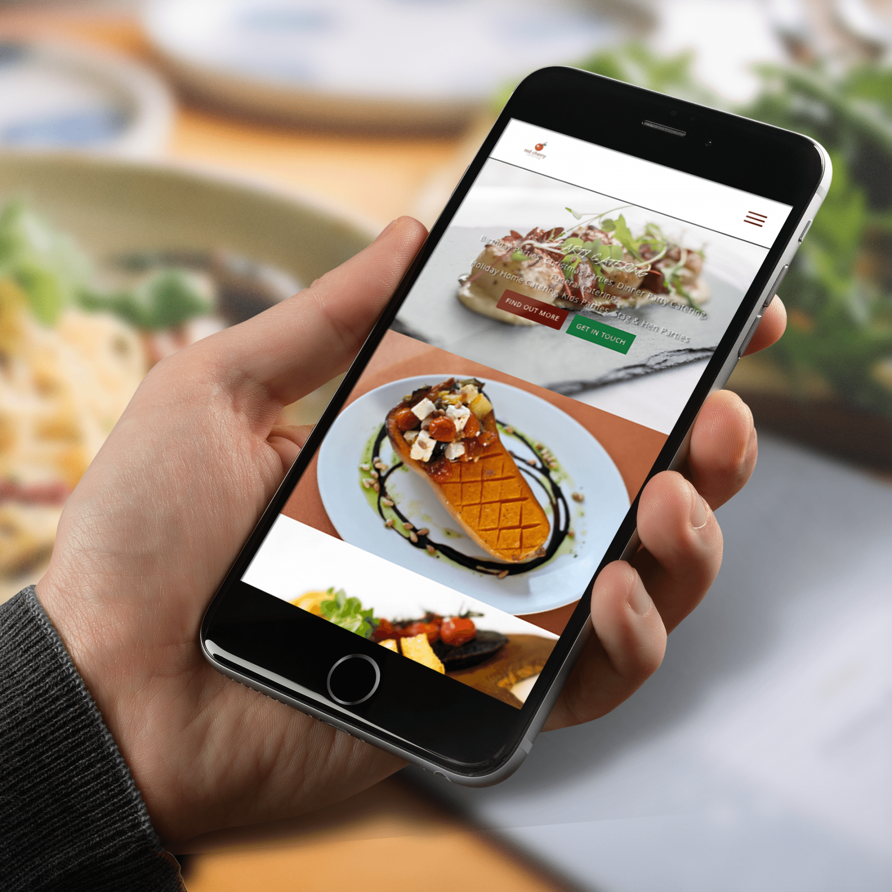 person looking at the red cherry catering website on mobile