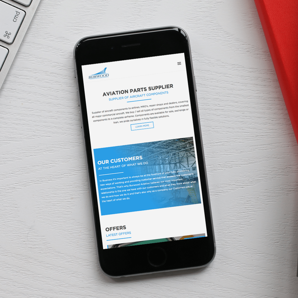 Burwood website on an iPhone, placed on a white desk